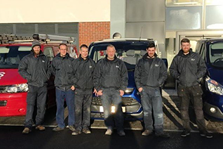 TRS Cooling team members stood in front of TRS Cooling vans
