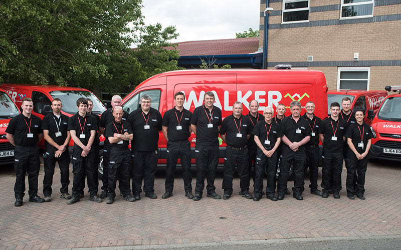 Walker Gas Services plumbing and heating engineers stood in front of Walker Gas Services van