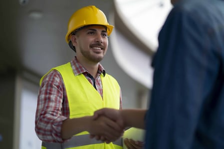Field service engineer shaking hands with customer