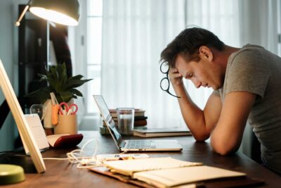 Stressed looking employee in their home office
