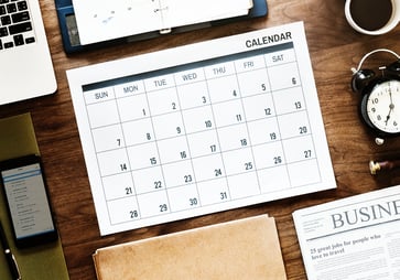 Monthly calendar lying on work desk